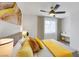 Bright bedroom featuring wood-look flooring, ceiling fan, a window and a desk at 9078 Hilverson Ave, Las Vegas, NV 89148
