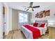 Bedroom with wood-look flooring, ceiling fan, and a window providing natural light at 9078 Hilverson Ave, Las Vegas, NV 89148