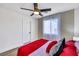 Bedroom with wood-look flooring, ceiling fan, and a window providing natural light at 9078 Hilverson Ave, Las Vegas, NV 89148