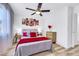Cozy bedroom with modern decor, decorative ceiling fan, bedside lamps, and a large window at 9078 Hilverson Ave, Las Vegas, NV 89148