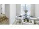 Elegant dining room with a modern table setting, white chairs, and plenty of natural light at 9078 Hilverson Ave, Las Vegas, NV 89148