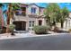 Exterior elevation of the home featuring a covered patio and desert landscaping at 9078 Hilverson Ave, Las Vegas, NV 89148