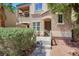 Home's front entrance with a metal gate and desert landscaping at 9078 Hilverson Ave, Las Vegas, NV 89148