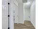 Hallway featuring doors, wood flooring, and neutral paint at 9078 Hilverson Ave, Las Vegas, NV 89148