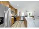 Modern kitchen boasts stainless steel appliances, stylish cabinets, and a large island with seating at 9078 Hilverson Ave, Las Vegas, NV 89148