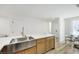 Spacious kitchen featuring a large stainless steel sink, stylish countertops and dining area at 9078 Hilverson Ave, Las Vegas, NV 89148