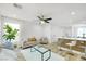 Bright living room with stylish furnishings, open to a modern kitchen with seating at 9078 Hilverson Ave, Las Vegas, NV 89148