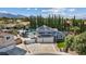 Areal view of a blue two-story house with a pool and a trailer parked on a concrete driveway at 9436 Darwell Dr, Las Vegas, NV 89117