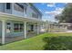 Backyard view of the home with a covered patio and well-maintained lawn at 9436 Darwell Dr, Las Vegas, NV 89117