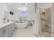 Bright bathroom featuring a soaking tub, walk-in shower, and vanity at 9436 Darwell Dr, Las Vegas, NV 89117