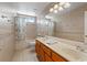Well-lit bathroom with a double sink vanity and shower-tub combination at 9436 Darwell Dr, Las Vegas, NV 89117