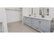 Elegant bathroom with double vanity, walk-in closet, and tile flooring at 9436 Darwell Dr, Las Vegas, NV 89117