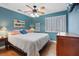 Cozy bedroom with a bright blue wall, shutters on the window, and a bed with decorative pillows at 9436 Darwell Dr, Las Vegas, NV 89117