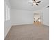 Large bedroom with ceiling fan, neutral carpet and stairway view at 9436 Darwell Dr, Las Vegas, NV 89117