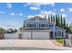 Charming two-story home with blue siding, black shutters, solar panels, and well-manicured lawn at 9436 Darwell Dr, Las Vegas, NV 89117