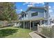 Rear exterior view of a two-story home with a covered patio and a green yard at 9436 Darwell Dr, Las Vegas, NV 89117