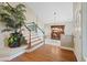 Spacious foyer with hardwood floors, staircase, large decorative plants, and high ceilings at 9436 Darwell Dr, Las Vegas, NV 89117
