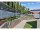 Backyard garden with concrete planters, irrigation system, and shaded canopy at 9436 Darwell Dr, Las Vegas, NV 89117