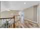 Light and airy hallway with wood floors and decorative railing at 9436 Darwell Dr, Las Vegas, NV 89117