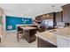 Stylish kitchen boasts dark cabinets, a spacious island, granite countertops, and stainless steel appliances at 9436 Darwell Dr, Las Vegas, NV 89117