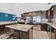 Contemporary kitchen with dark wood cabinetry, granite countertops, stainless steel appliances, and ample counter space at 9436 Darwell Dr, Las Vegas, NV 89117