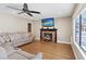 Inviting living room with a fireplace, ceiling fan, hardwood floors, and view to the outdoor area at 9436 Darwell Dr, Las Vegas, NV 89117