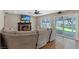 Bright living room features a fireplace, hardwood floors, and sliding glass doors to the backyard at 9436 Darwell Dr, Las Vegas, NV 89117