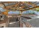 Outdoor kitchen and bar under a gazebo, perfect for entertaining guests by the pool at 9436 Darwell Dr, Las Vegas, NV 89117