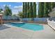 Sparkling swimming pool and spa surrounded by a concrete patio and manicured landscaping at 9436 Darwell Dr, Las Vegas, NV 89117