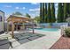Backyard pool and spa with a gazebo, outdoor kitchen, and ample patio space for entertaining at 9436 Darwell Dr, Las Vegas, NV 89117
