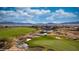 Aerial view of the community pool with mountains in the background, a pond, and golf course at 977 Majestic Vw, Mesquite, NV 89034