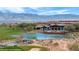 Aerial view of the community pool with mountains in the background, a pond, and golf course at 977 Majestic Vw, Mesquite, NV 89034