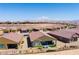 Backyard view showcasing a covered patio, turf area, desert landscape, and mountain views at 977 Majestic Vw, Mesquite, NV 89034