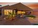 Beautiful backyard with covered patio, desert landscaping, and custom inlaid pavers and turf at 977 Majestic Vw, Mesquite, NV 89034