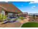 Backyard with desert landscaping, covered patio, and inlaid brick pavers at 977 Majestic Vw, Mesquite, NV 89034