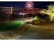 Backyard at night featuring a view of fireworks, desert landscaping, and synthetic grass at 977 Majestic Vw, Mesquite, NV 89034