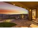 Relax on the covered patio with string lights, offering beautiful views and desert landscaping at 977 Majestic Vw, Mesquite, NV 89034