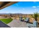 Desert landscaped backyard with brick paver patio offering mountain views from behind iron fence at 977 Majestic Vw, Mesquite, NV 89034