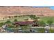 Clubhouse view showcasing parking, desert landscaping, and picturesque mountains at 977 Majestic Vw, Mesquite, NV 89034