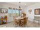 Charming dining area with a wooden table, shuttered windows with backyard views, and decorative accents at 977 Majestic Vw, Mesquite, NV 89034