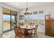 Bright dining area with a wooden table, sliding glass doors to the patio, and mountain views at 977 Majestic Vw, Mesquite, NV 89034