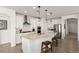 Modern kitchen with a large island, white cabinets, stainless steel appliances, and pendant lighting at 977 Majestic Vw, Mesquite, NV 89034