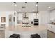 Stylish kitchen features a large island, quartz countertops, pendant lights, and ample storage space at 977 Majestic Vw, Mesquite, NV 89034