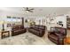 Open-concept living room flows into the kitchen, with leather seating and neutral decor at 977 Majestic Vw, Mesquite, NV 89034