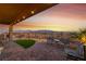 Relaxing patio featuring mountain views, outdoor seating, decorative rocks, and artificial turf at 977 Majestic Vw, Mesquite, NV 89034
