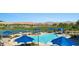 Community pool with lounge seating with views of the surrounding desert landscape and golf course at 977 Majestic Vw, Mesquite, NV 89034