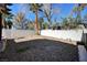 A low-maintenance backyard features a rock landscape, a privacy wall, and a mature palm tree at , Henderson, NV 89014