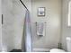 Well-lit bathroom with a tiled shower, gray accent towel, and a framed picture that adds a personal touch at , Henderson, NV 89014
