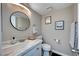 Bathroom featuring a marble countertop, round mirror and neutral decor at , Henderson, NV 89014