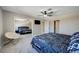 Bedroom featuring a ceiling fan, a patterned bedspread, neutral walls, carpet and a mirrored closet at , Henderson, NV 89014